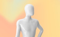 a white mannequin standing in front of a yellow background